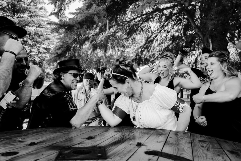 Bride and groom arm wrestling
